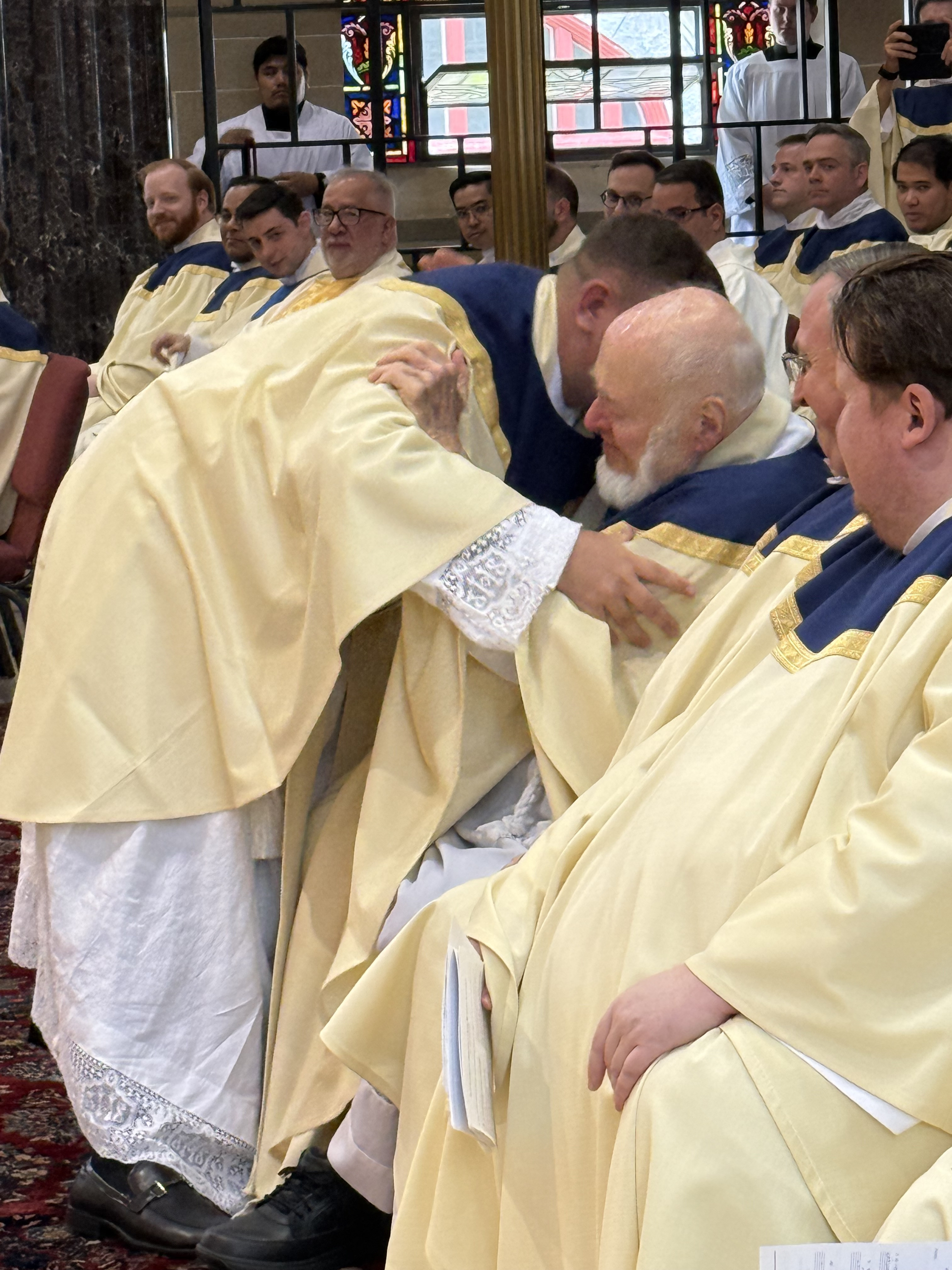Father Alan Bridges embraces his vesting priest, Father Michael Roach, a retired priest from Maryland who lives and works at Mount St. Mary Seminary and his mentor. EmmaLee Italia photo, trentonmonitor.com